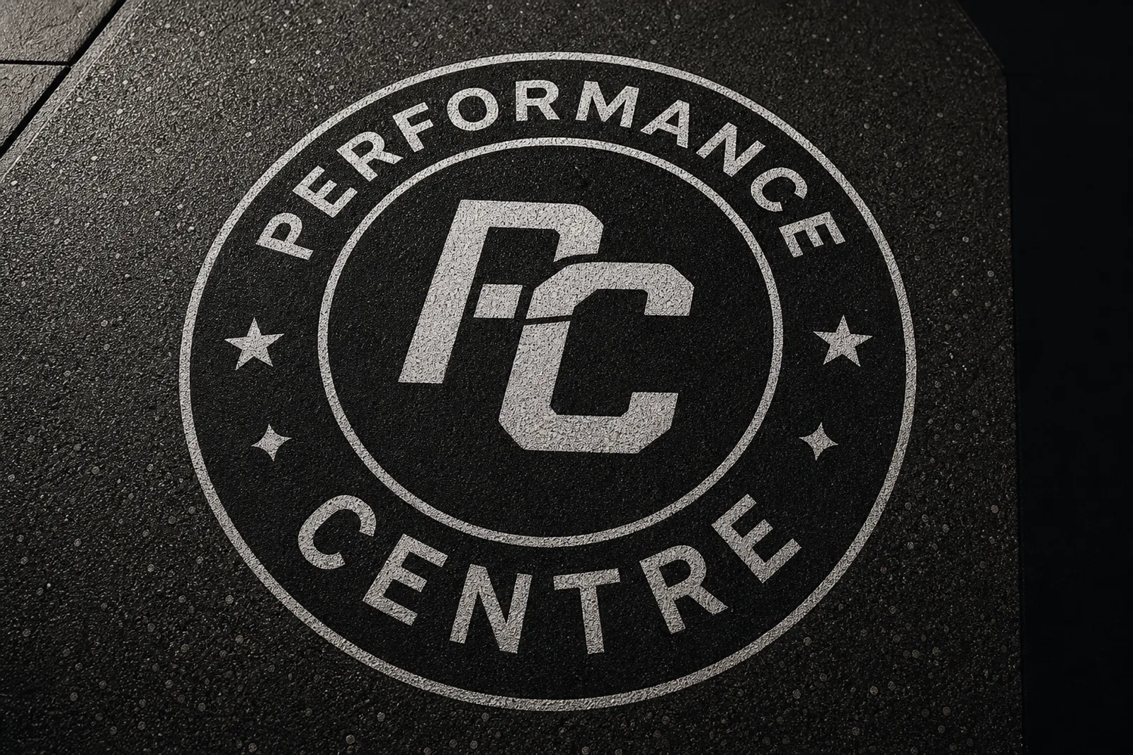 Circular performance centre logo in rubber floor